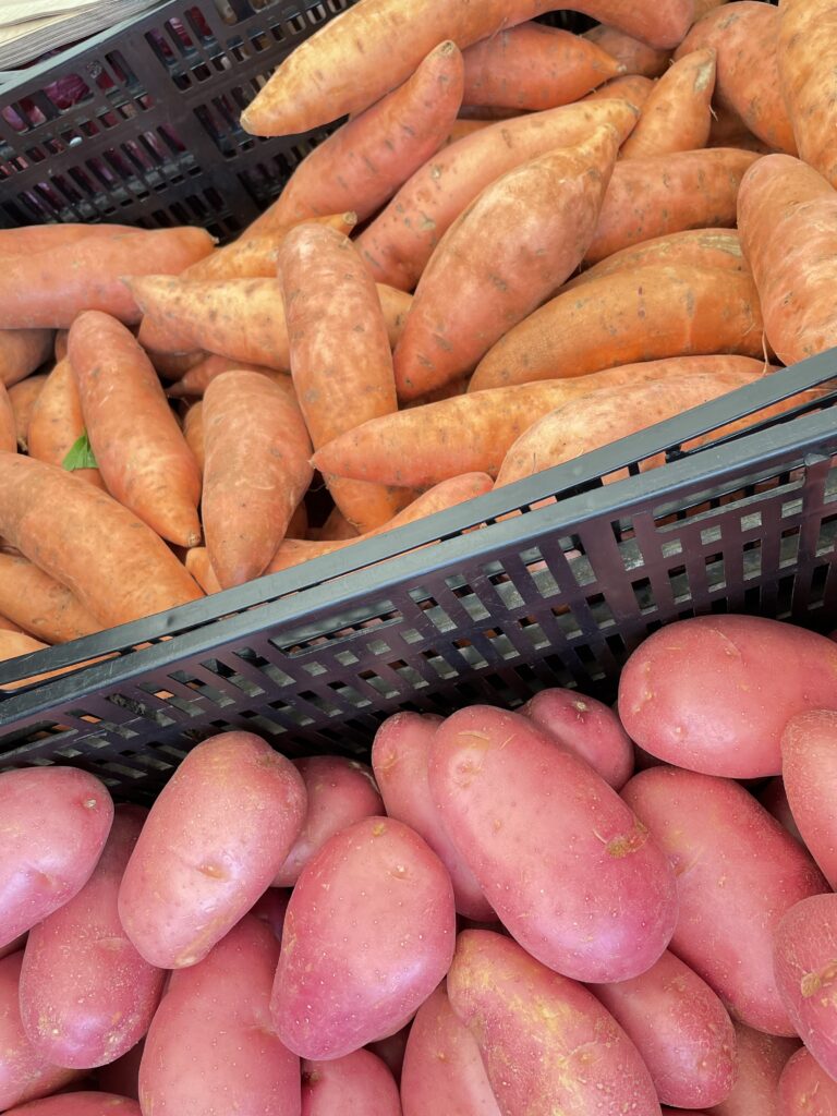 Farmers Market stall with sweet and red potatoes