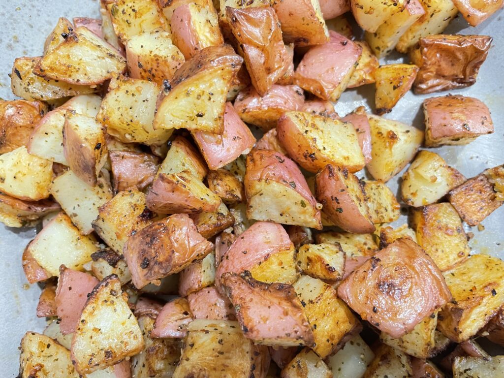 Roast potato chunks on parchment paper