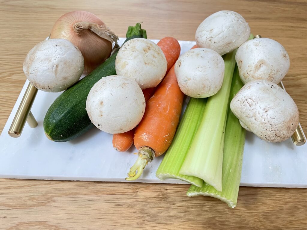 Vegetables on white tray with golden handles