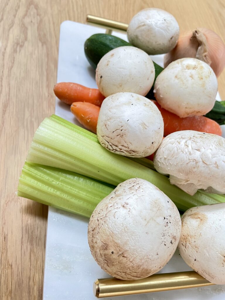 Vegetables on tray with golden handles on wooden table