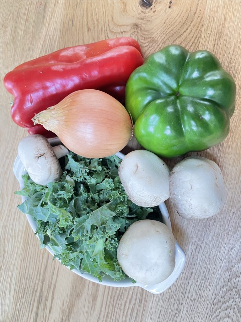 Capsicum, kale, onion and mushroom on table