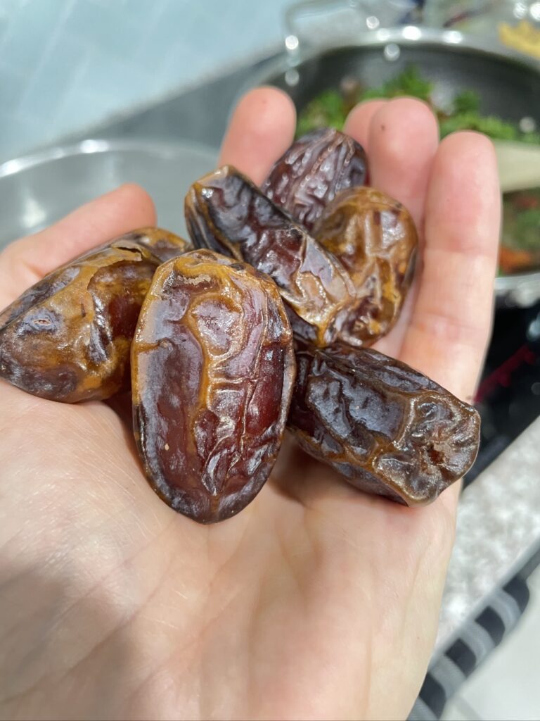 Hand holding medjool dates