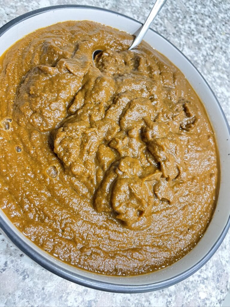 Blended vegetable pasta sauce in bowl with ladle