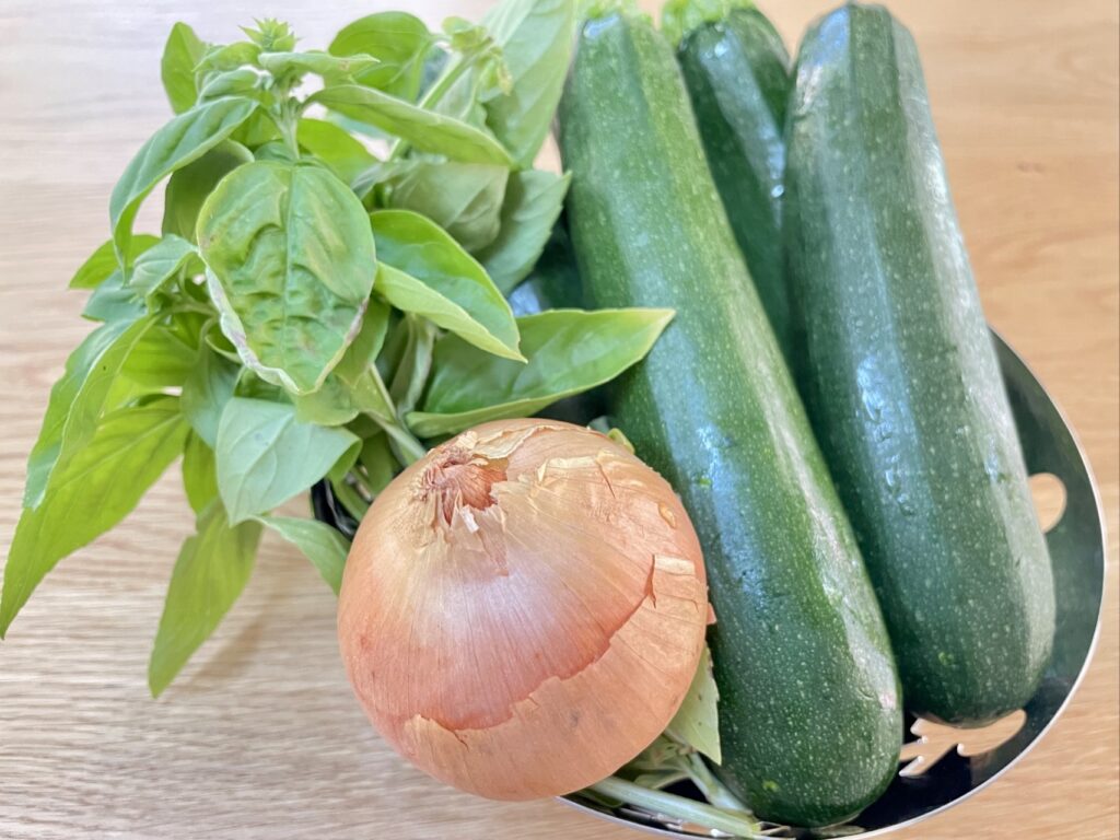 Bowl of zucchini, onion and basil