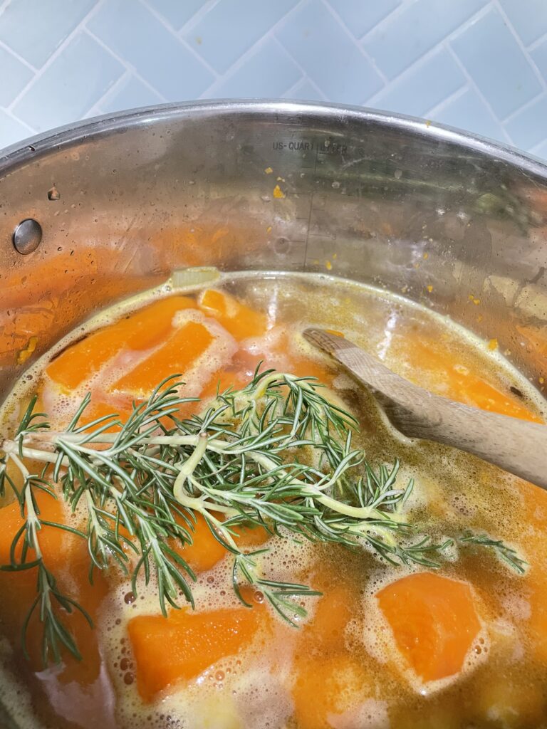 Large pot with carrots and rosemary