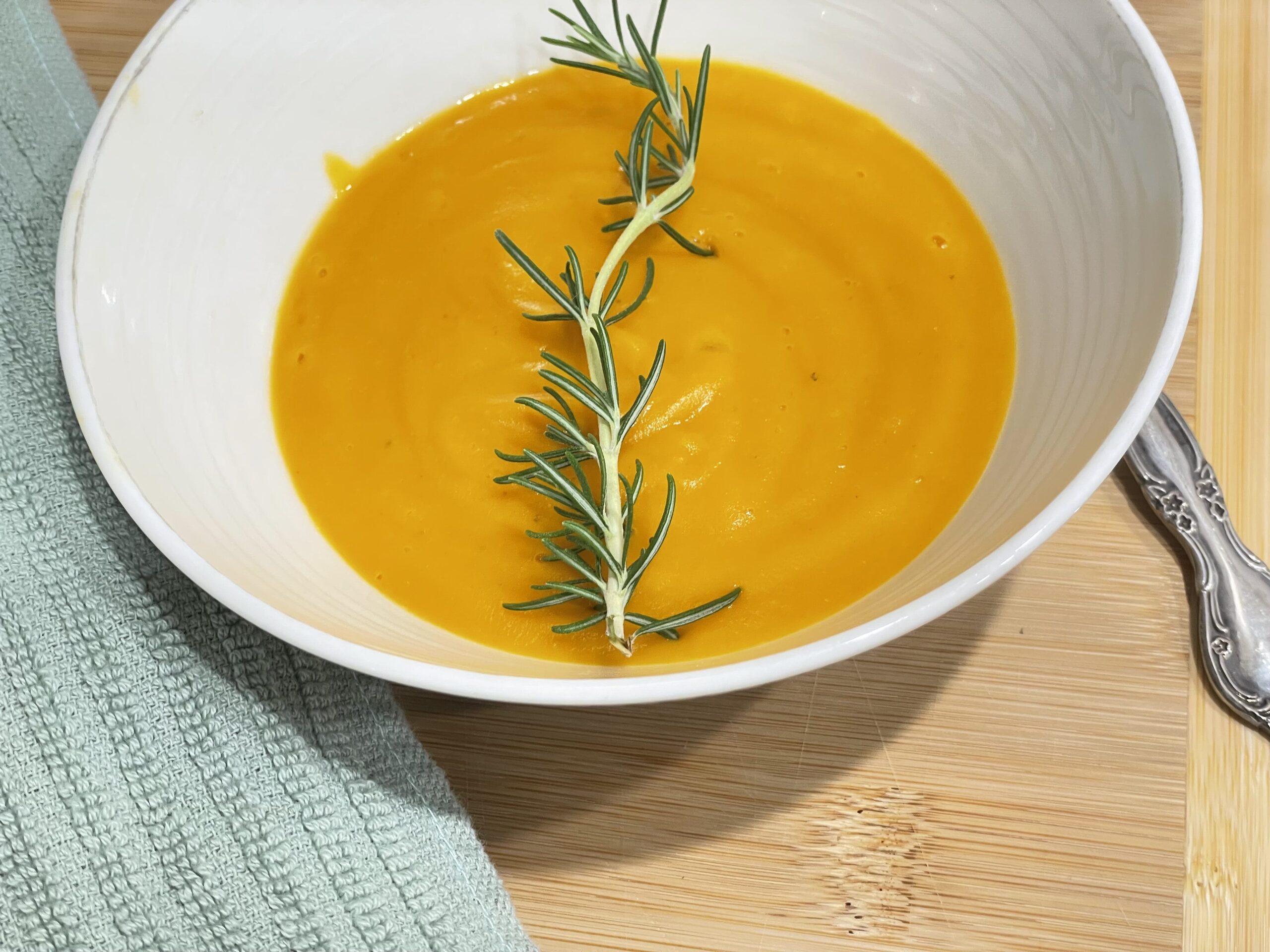 Bowl of carrot soup with napkin