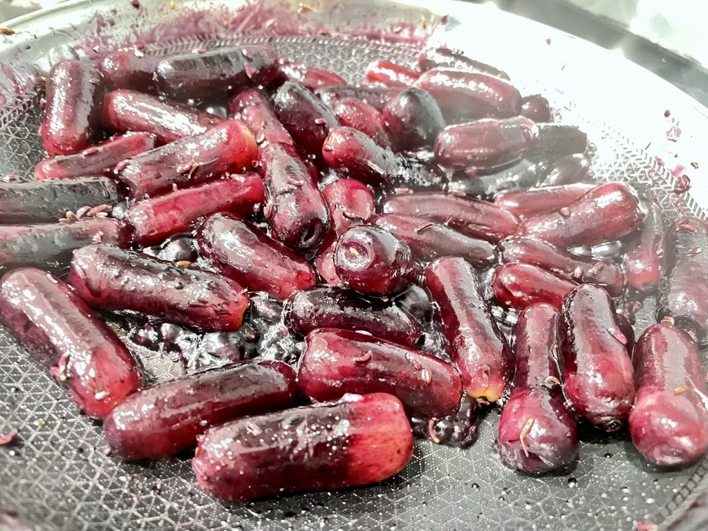 Sizzling grapes in frying pan