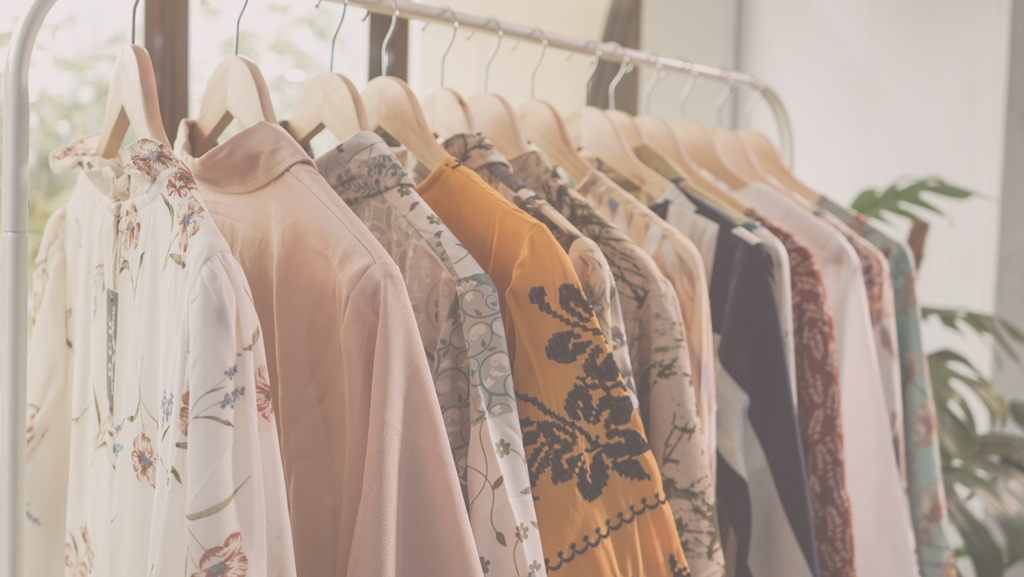 Selection of women’s tops hanging on coat rack