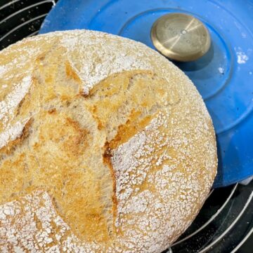 Cooling rack with blue pot lid and sourdough loaf