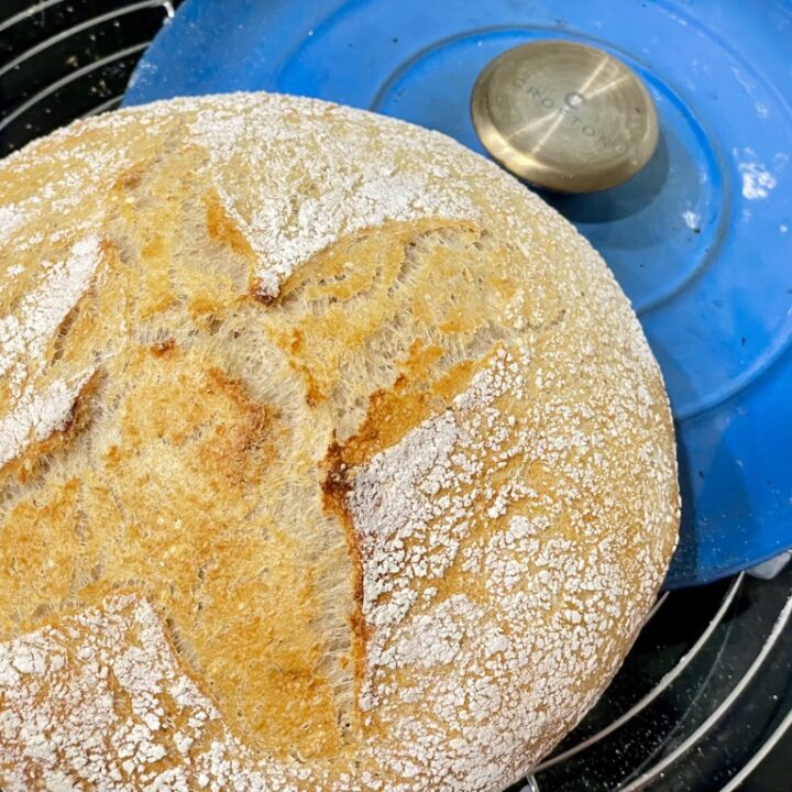 Cooling rack with blue pot lid and sourdough loaf