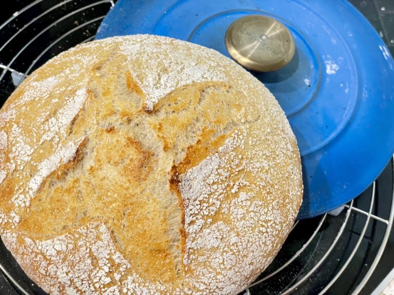 Cooling rack with blue pot lid and sourdough loaf