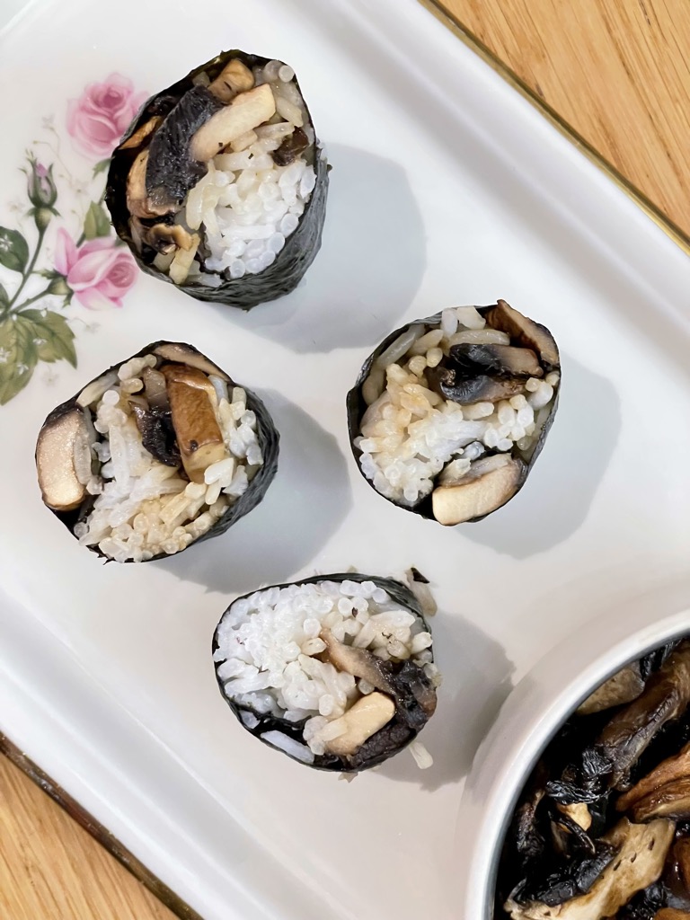 Mushroom sushi on white floral platter