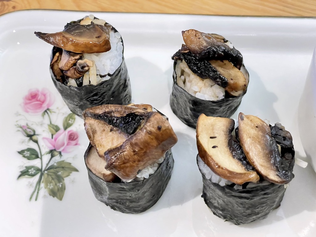 Four pieces of mushroom sushi on platter