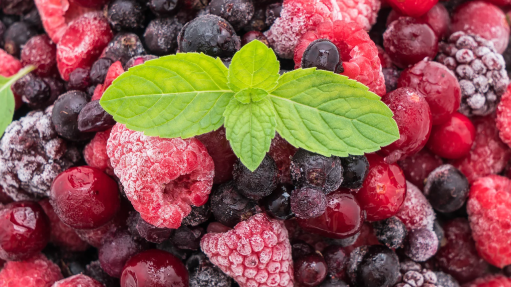 Close up shot of frozen berries with mint leaves