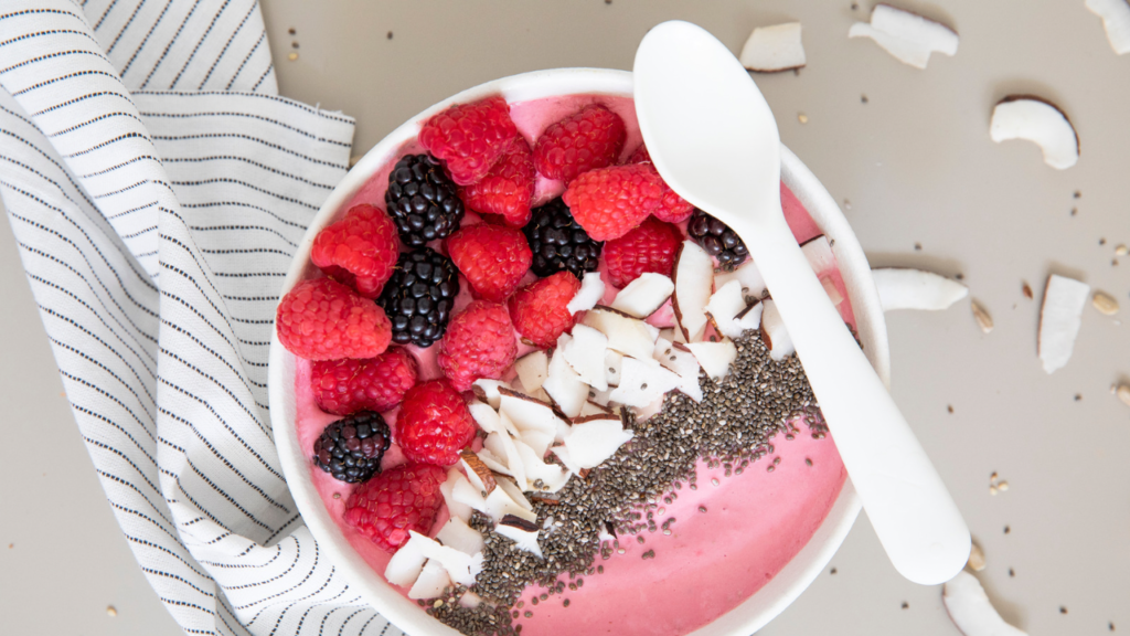 Pink smoothie bowl with berry toppings