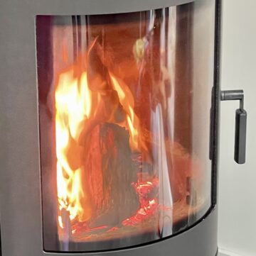 Close up shot of fireplace with fire burning inside