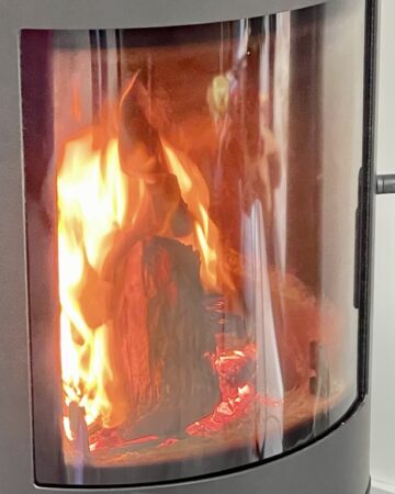 Close up shot of fireplace with fire burning inside