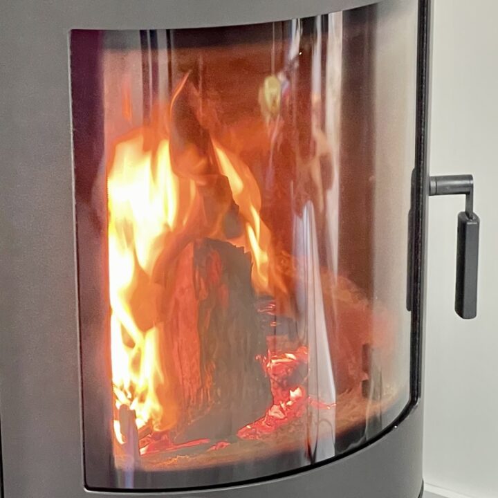 Close up shot of fireplace with fire burning inside