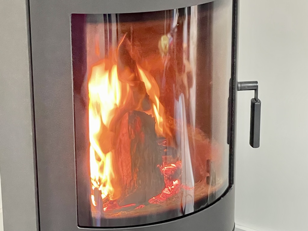 Close up shot of fireplace with fire burning inside