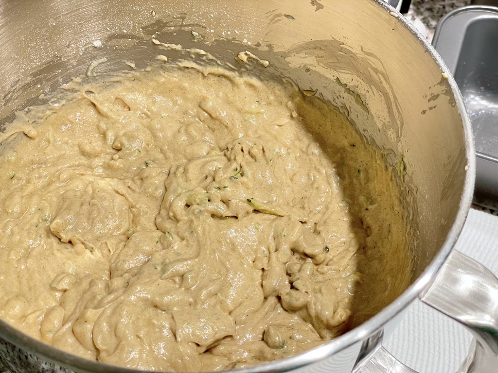 Sourdough discard zucchini dough in silver mixing bowl