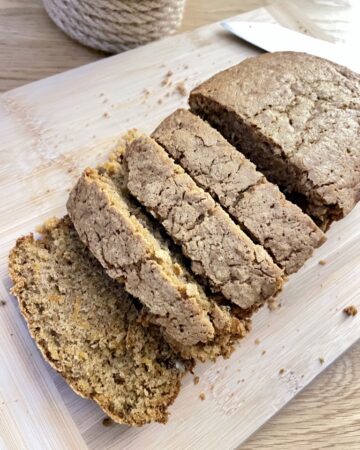 Wooden board with sliced sourdough discard carrot cake without frosting