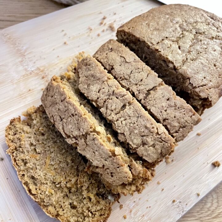 Wooden board with sliced sourdough discard carrot cake without frosting