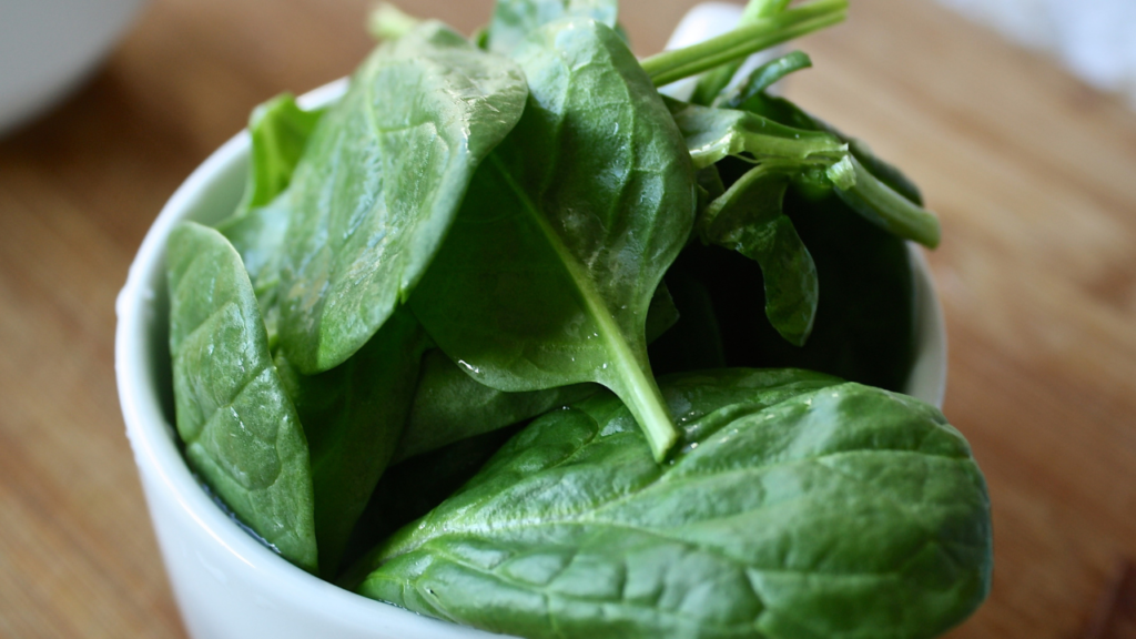 Cup filled with spinach leaves