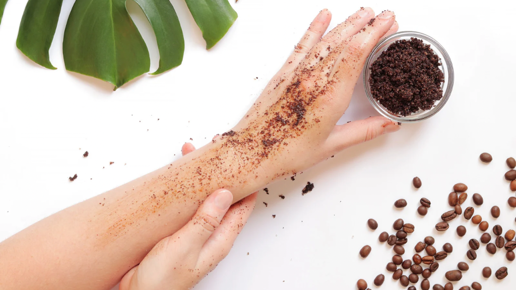 Female applying coffee scrub on arm