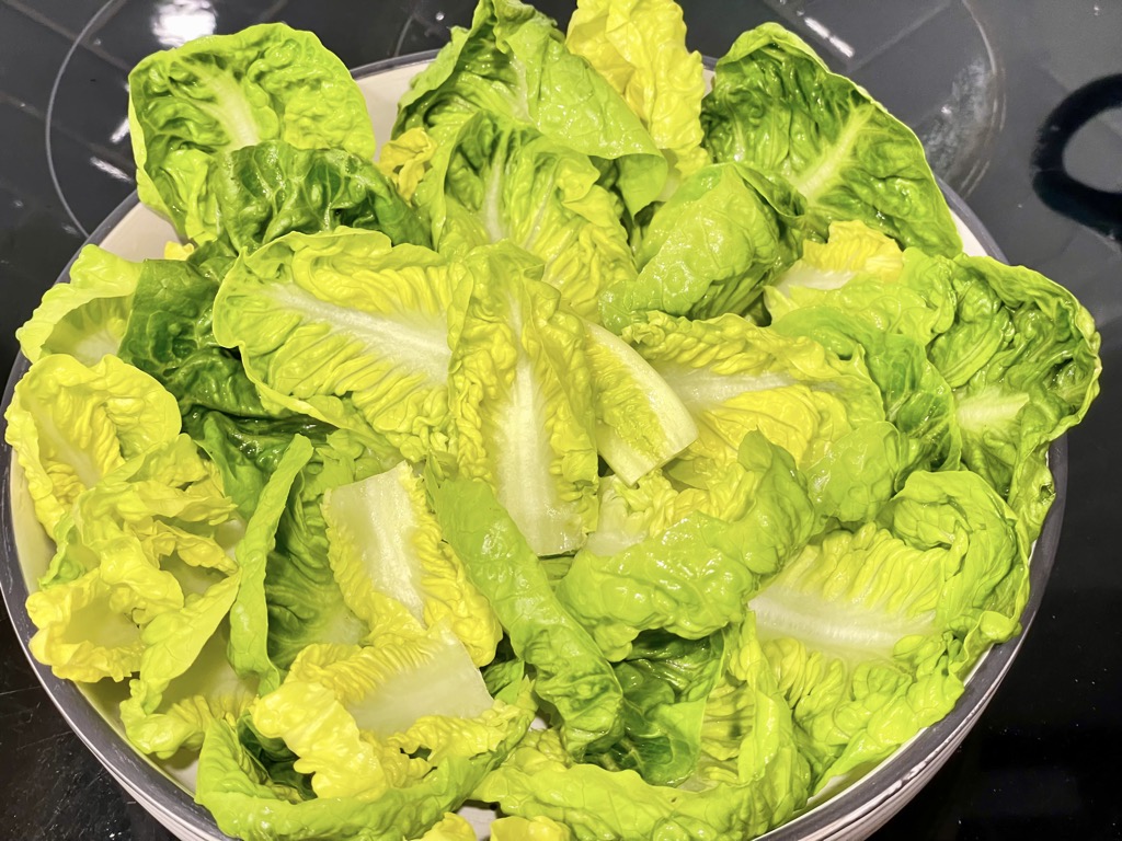 Bowl of salad greens on stove