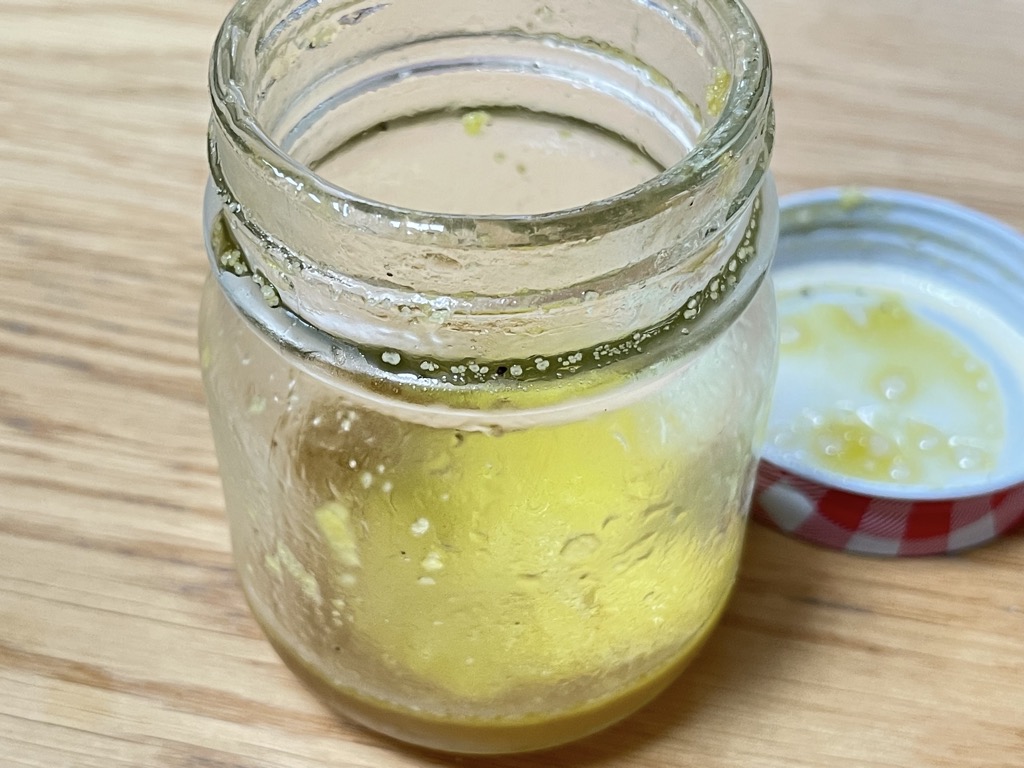 Open jar with salad dressing