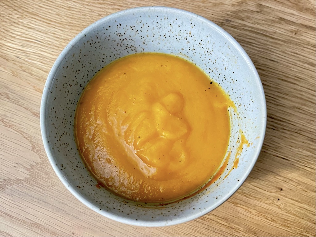 Top down shot of sweet potato soup in bowl on table