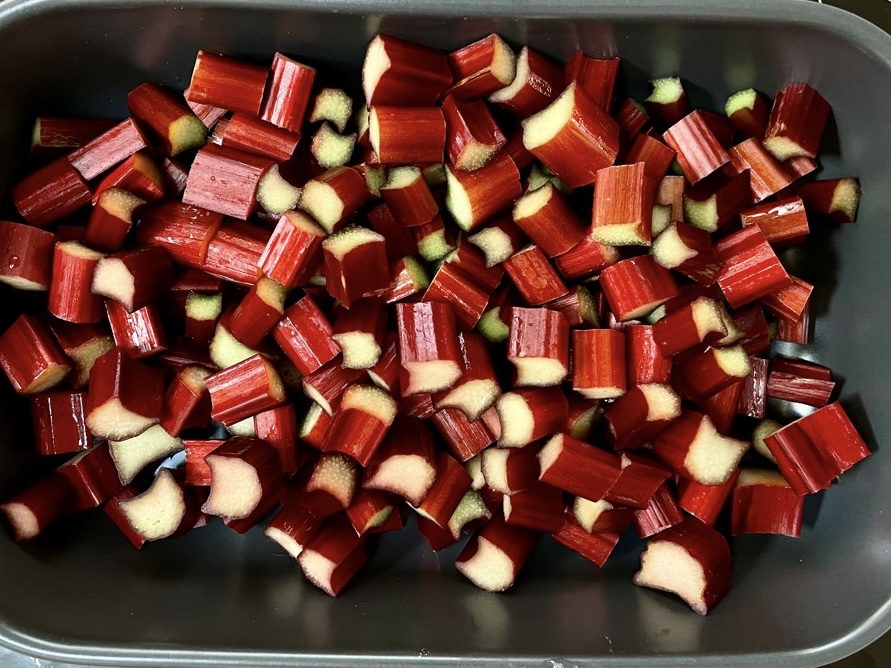 Fresh rhubarb pieces in black oven dish