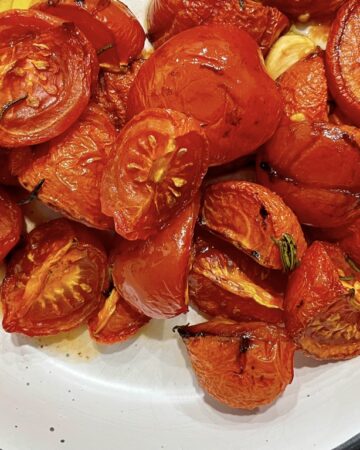 Slow roasted confit tomatoes in white serving bowl