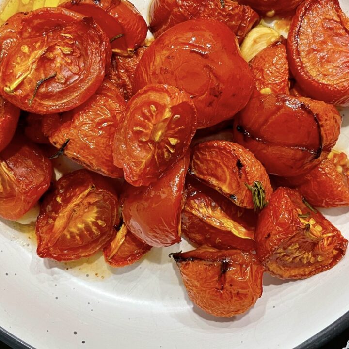 Slow roasted confit tomatoes in white serving bowl