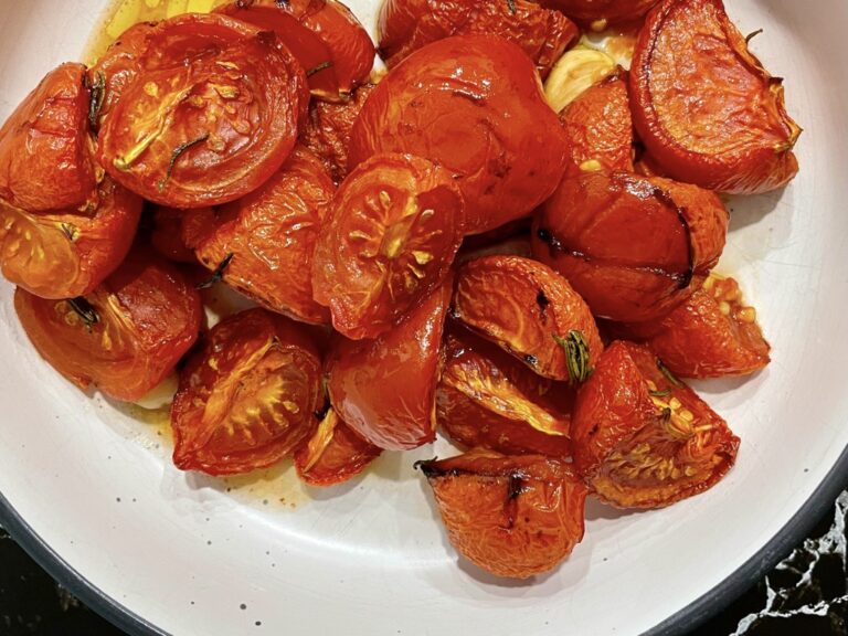 Slow roasted confit tomatoes in white serving bowl