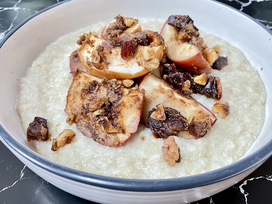 Rice flake porridge in bowl topped with bratapfel pieces and crunchy granola