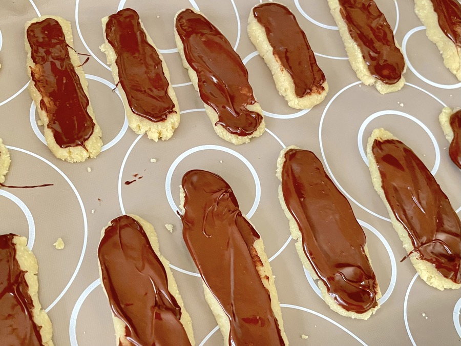 Milk chocolate marzipan bars laid out on silicone mat