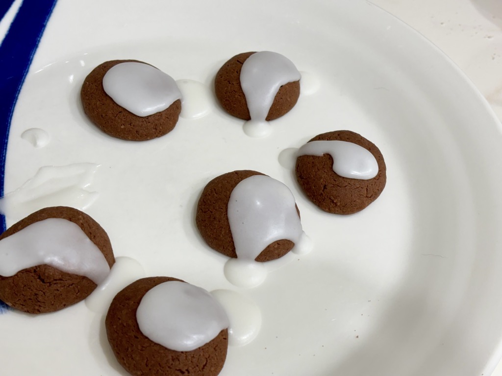 Nutella biscuits topped with white icing on plate