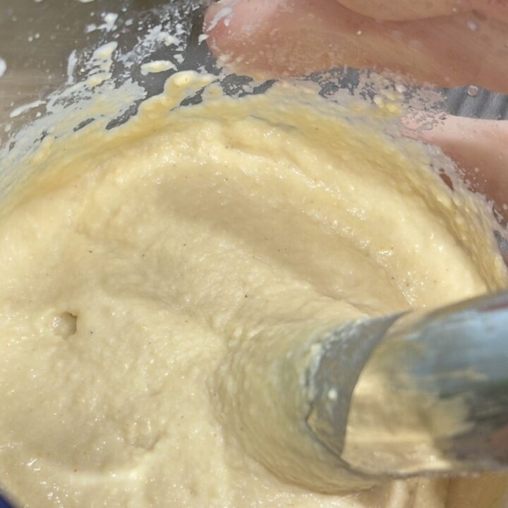 Creamy hummus being blended in clear container