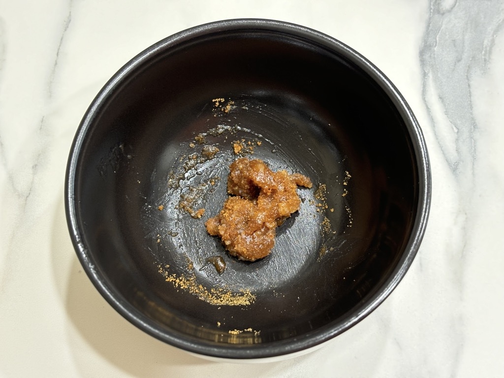 Black bowl filled with small amount of homemade lip exfoliator