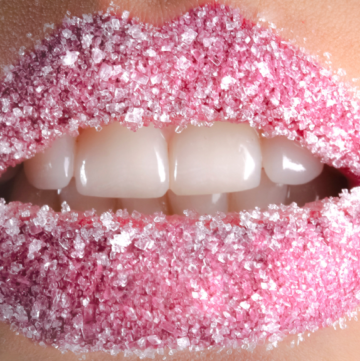 Close up shot of pink lips covered with sugar scrub