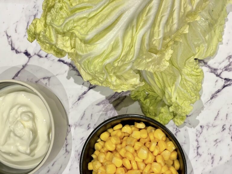 Napa cabbage, bowl of corn and bowl of yoghurt on kitchen bench