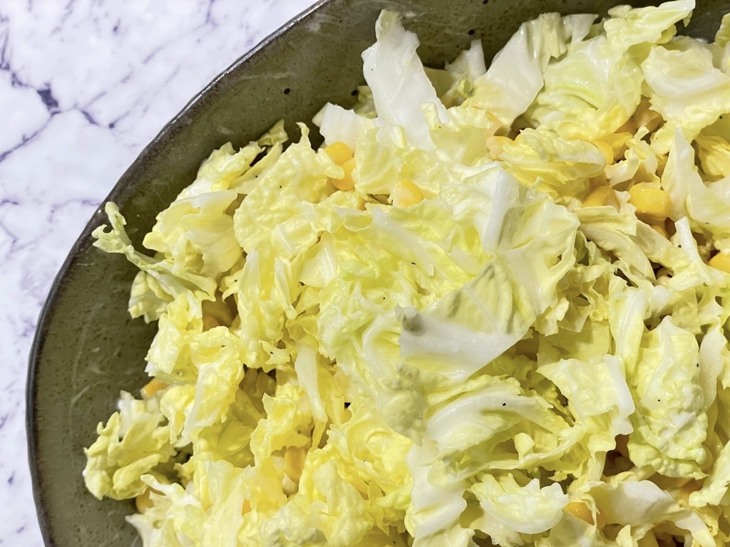 Creamy salad with corn in salad bowl