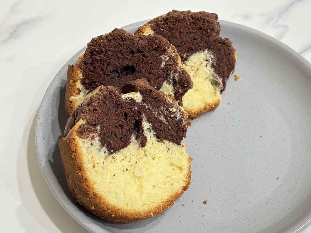 Three slices of marmorkuchen on grey plate