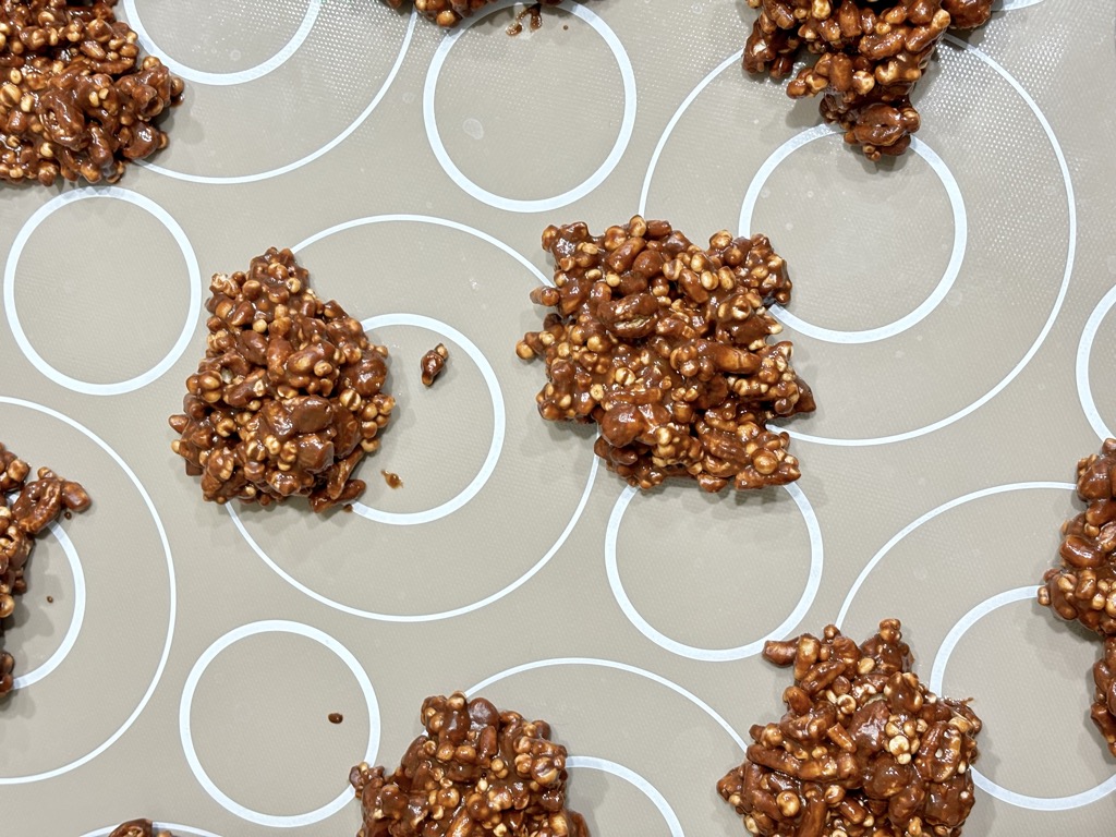 Chocolate covered crunch bites on baking sheet