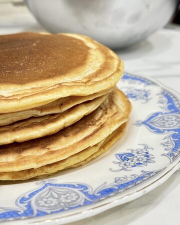 Stack of pancakes on blue and white plate