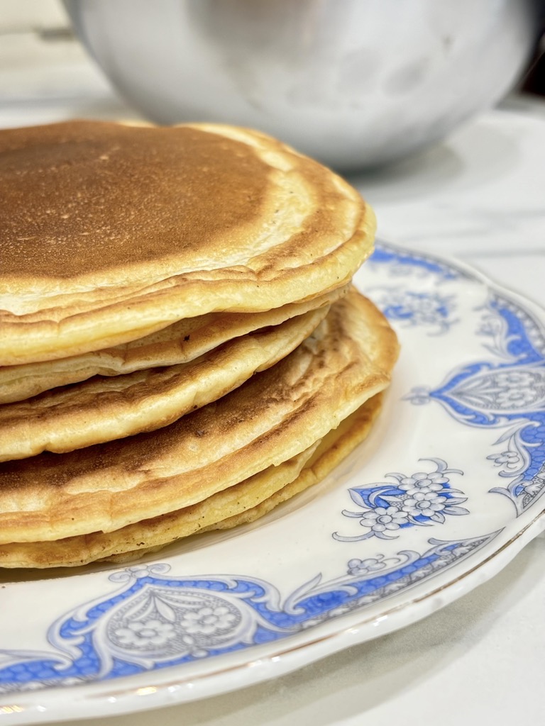 Stack of pancakes on blue and white plate