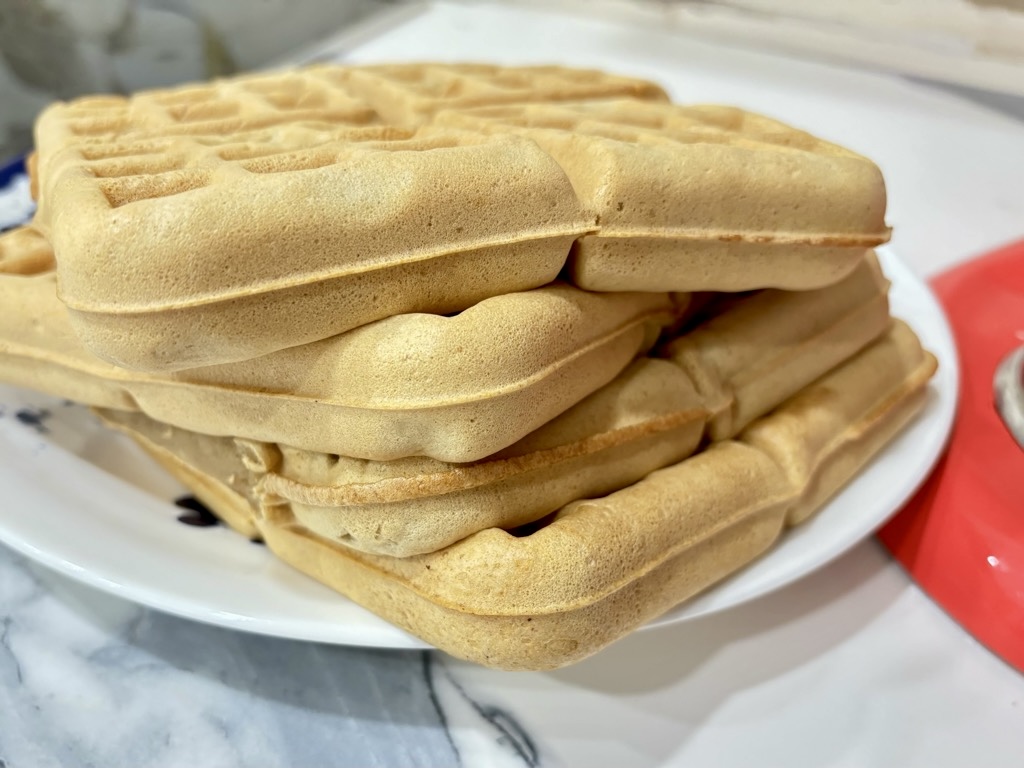 Stack of square waffles on white plate