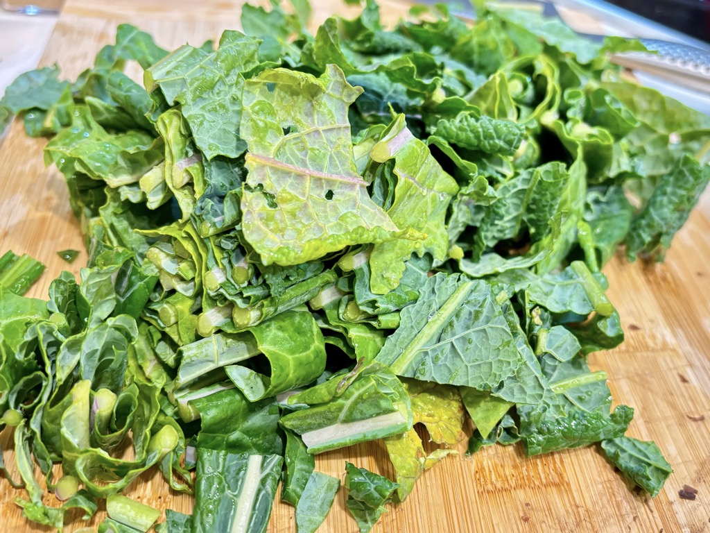 Chopped kale leaves on wooden board