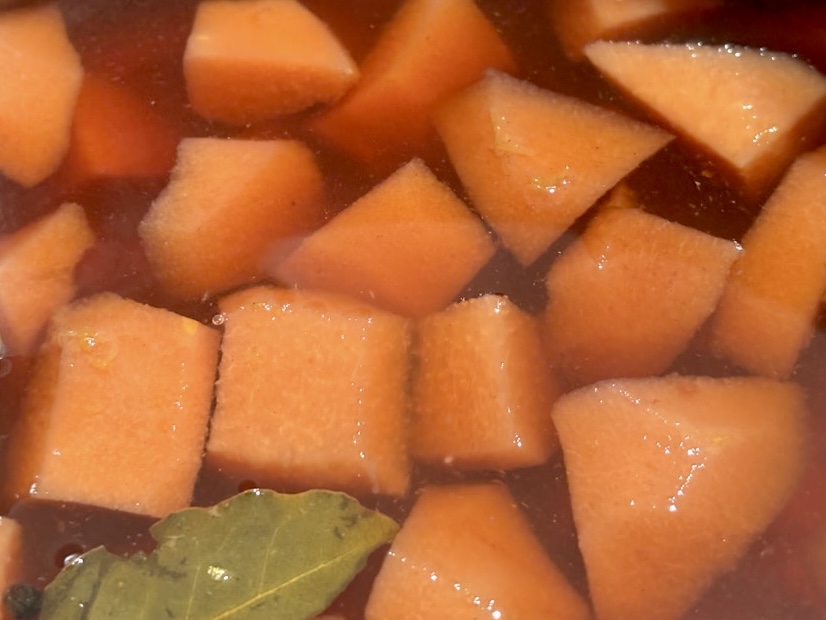 quince pieces in liquid with bayleaf